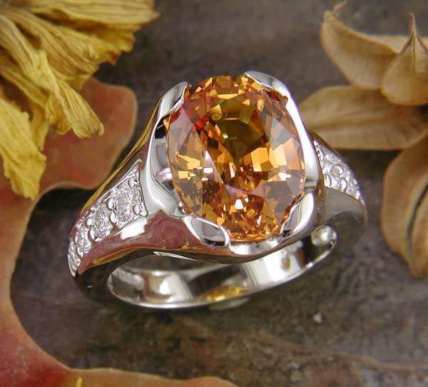 14K white gold with 6.96 ct. golden orange sapphire and .44 carats of diamond accent.