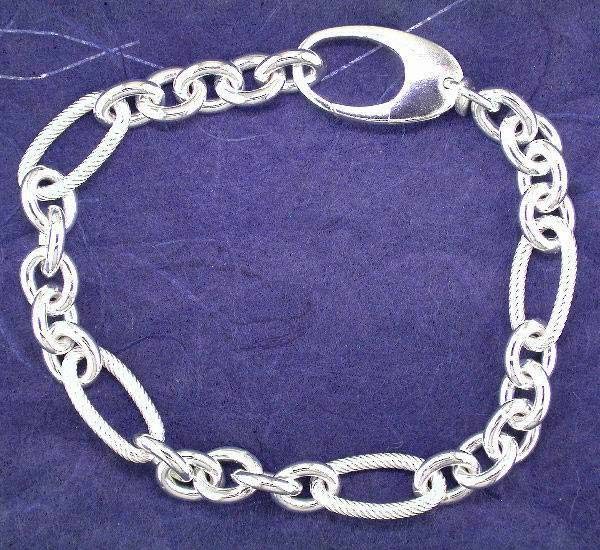 Polished and twist link sterling silver bracelet with large lobster clasp.