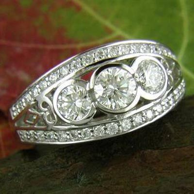 Three stone ring available in many different total carat weights. Streamlined elegance at it's best.